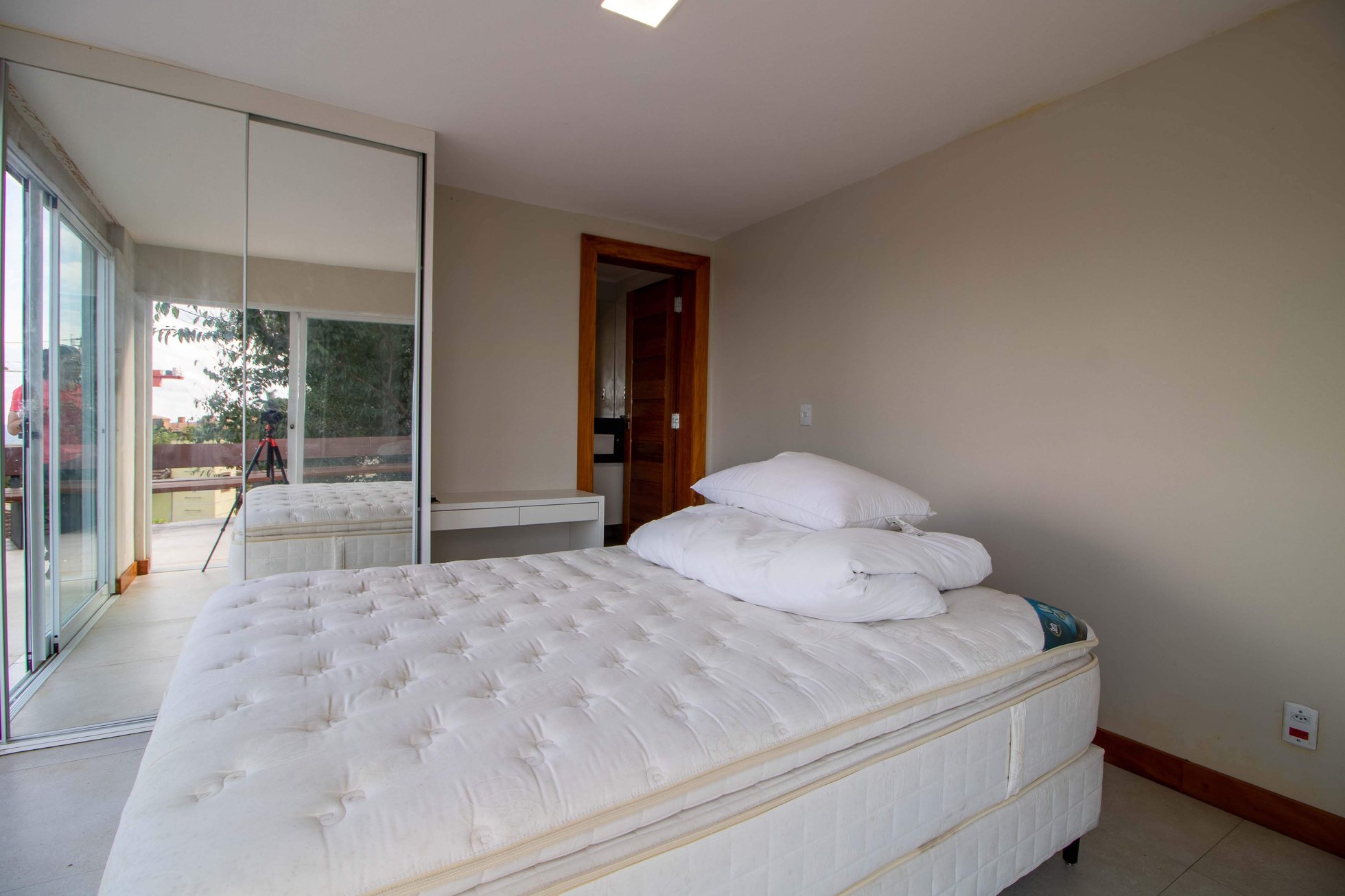 Soft bed with white mattress in modern bedroom